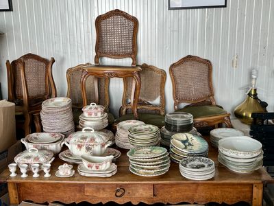 une table sur laquelle se trouvent beaucoup d'assiettes et de bols
