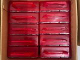 a box filled with red plastic containers sitting on top of a table