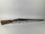 a shotgun with a wooden barrel and a wooden handle