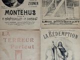 several old french newspapers are stacked on top of each other