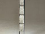 a tall metal and glass floor lamp with a black base