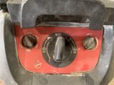 a close up of a red and black oven