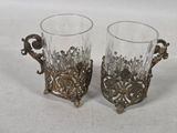 pair of antique glass vases with ornate handles on white background