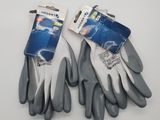two pairs of gardening gloves on a white surface