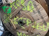 a wooden spool with graffiti on it sitting on the ground