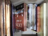 many books that are on a shelf in the room