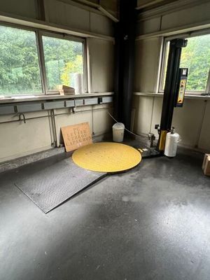 a yellow table in a room with a lot of windows