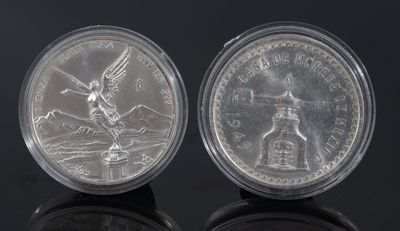 an image of a pair of silver coins sitting on top of a black surface