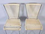 pair of vintage wicker chairs with chrome legs