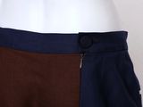 a close up of a mannequin torso wearing a brown and blue skirt