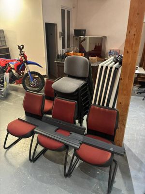 several chairs and a table in a room with a motorcycle in the background