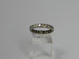 a close up of a ring on a clear stand on a white surface
