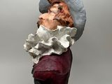 a sculpture of a woman with a bird on her head