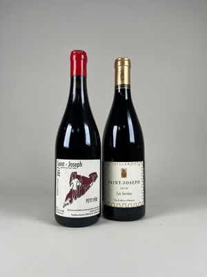 two bottles of wine sitting next to each other on a table