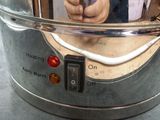 a person taking a selfie in the mirror of a coffee pot