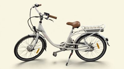a white bike with a basket on the back of it
