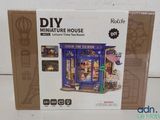 a box with a doll house inside of it