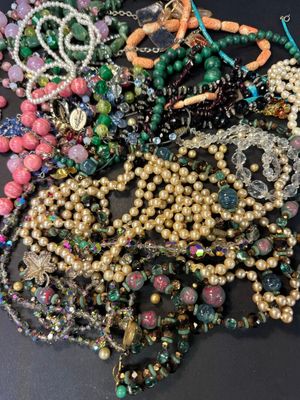 a lot of beads and necklaces on a table
