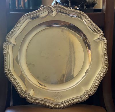 a silver plate sitting on top of a chair
