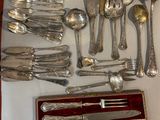 a lot of silverware on display on a table