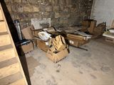 a pile of cardboard boxes in a room with stairs