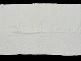 a close up of a piece of white paper on a black background