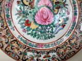 a colorful plate with a rose on it on a table