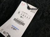 a close up of a black dress with a price tag on it