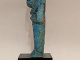 statue of a man holding a baby on a black base
