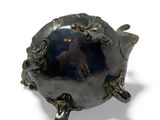 an image of a silver turtle with a blue stone in its shell
