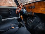 a steering wheel and dashboard of a car with a brick wall in the background