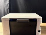 a white printer sitting on top of a wooden table