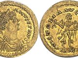 a gold coin with an image of a woman on it