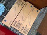 two boxes of scissors sitting on top of a wire rack