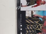 a close up of a person wearing a pirate costume on a white surface