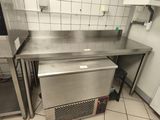un plan de travail en acier inoxydable dans une cuisine équipée d'un lave-vaisselle
