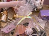 a bag of stuff on a table next to a pair of shoes and a baseball bat