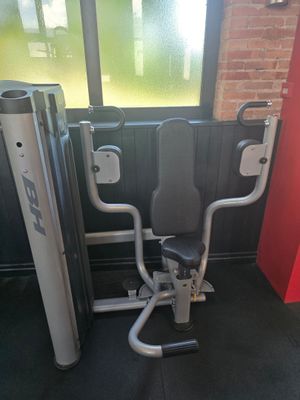 doorway view of a gym room with a bench, exercise equipment, and a window