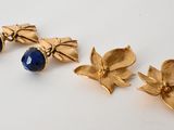 a pair of gold earrings with blue stones on them