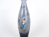 un vase bleu sur lequel est peinte une femme
