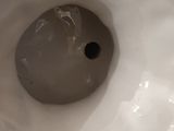 a close up of a white porcelain toilet with the lid down