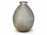 a glass vase that is sitting on a white surface