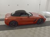 an image of an orange sports car parked in a garage
