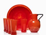a lot of red glassware sitting on a white surface