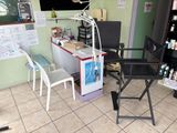 an image of a salon with a desk and chairs