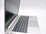 a laptop computer sitting on a white surface