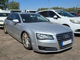 a silver audi parked in a parking lot with other cars in the background