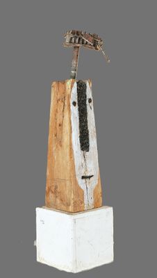 a sculpture of a bird on top of a piece of wood