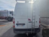 a white van parked in a parking lot with a ladder attached to the back of it
