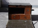an old wooden box with two drawers on it
